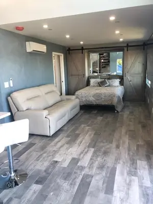 a living room with a couch and a bed at LOVE SHACK on private canyon, minutes to the Beach in San Diego