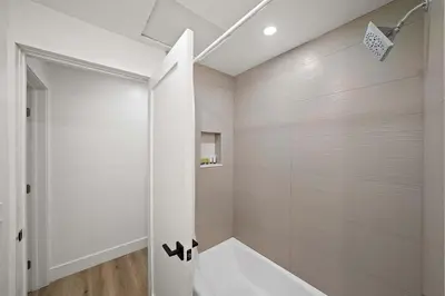 a white bathroom with a tub and a shower at Explore South Park from 2-Story Home Sleeps 8 in San Diego