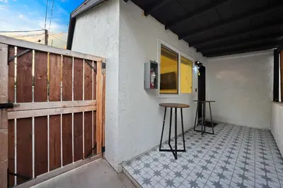 a patio with a wooden gate and a stool at Explore South Park from 2-Story Home Sleeps 8 in San Diego