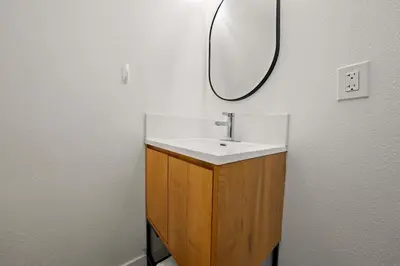 a bathroom with a sink and a mirror on the wall at Explore South Park from 2-Story Home Sleeps 8 in San Diego