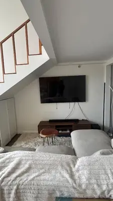 a bedroom with a bed and a flat screen tv at Loft on 6th and Market in San Diego
