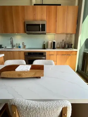 a kitchen with a table with chairs and a microwave at Loft on 6th and Market in San Diego