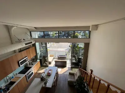 a view of a kitchen and living room with a large window at Loft on 6th and Market in San Diego