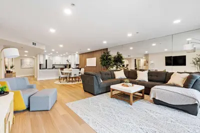 a living room with two couches and a kitchen at Bay View Penthauz Monthly Rental 2 parking spots in San Diego