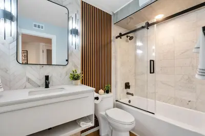 a bathroom with a toilet and a sink and a mirror at Bay View Penthauz Monthly Rental 2 parking spots in San Diego