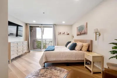 a bedroom with a bed and a large window at Bay View Penthauz Monthly Rental 2 parking spots in San Diego