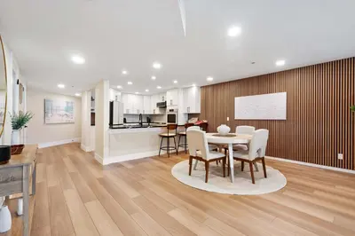 a dining room and kitchen with a table and chairs at Bay View Penthauz Monthly Rental 2 parking spots in San Diego
