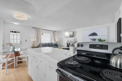 a kitchen with a stove and a counter top at Steps to Windnsea Beach | Parking, Patio, Location! in San Diego