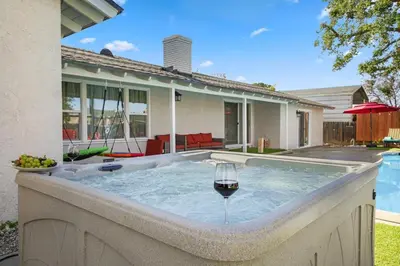 a hot tub in the backyard of a house at Sleeps 12 - Hot Tub - Pool - Game Room & Fire Pit! in Hemet