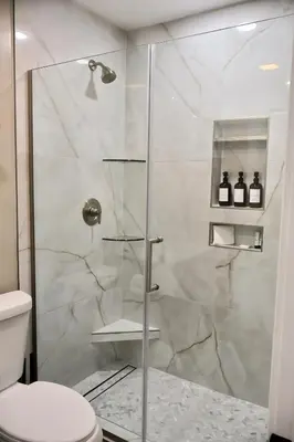 a bathroom with a glass shower with a toilet at 2 Masters, Newly renovated with new furnishings - 4BR 3BA in San Diego