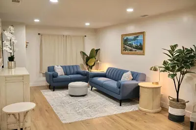 a living room with two blue couches and a rug at 2 Masters, Newly renovated with new furnishings - 4BR 3BA in San Diego