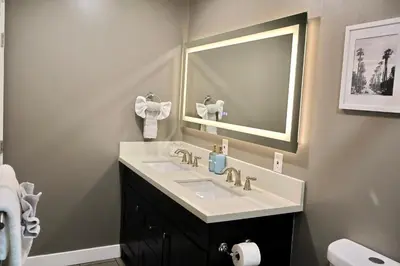 a bathroom with a sink and a mirror at 2 Masters, Newly renovated with new furnishings - 4BR 3BA in San Diego