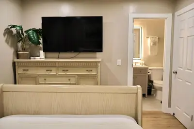 a living room with a tv on top of a dresser at 2 Masters, Newly renovated with new furnishings - 4BR 3BA in San Diego
