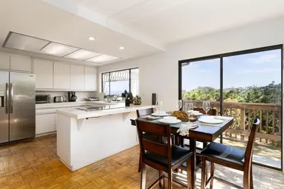 a kitchen and dining room with a table and chairs at Spacious 4BD, La Jolla, Ocean Views, Jacuzzi in San Diego