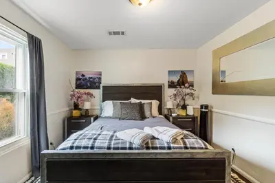 a bedroom with a bed and a large window at Bungalow Downtown Easy Airport Access Family Friendly in San Diego