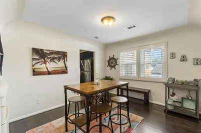 a dining room with a table and stools at Bungalow Downtown Easy Airport Access Family Friendly in San Diego