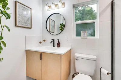 a bathroom with a toilet and a sink and a mirror at Sip, Golf and Unwind Couples Retreat in Fallbrook in Fallbrook