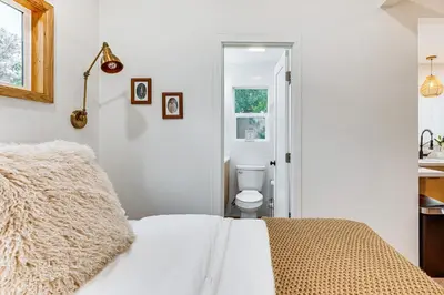 a bedroom with a bed and a toilet in a room at Sip, Golf and Unwind Couples Retreat in Fallbrook in Fallbrook