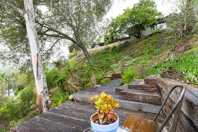 a table with a potted plant on top of stairs at Sip, Golf and Unwind Couples Retreat in Fallbrook in Fallbrook