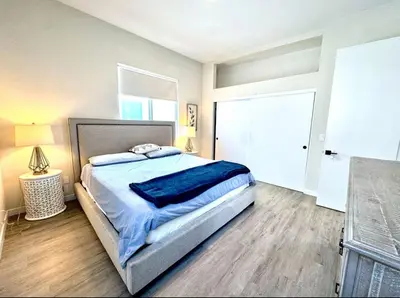a bedroom with a bed with a blue blanket on it at Central SD Townhome 2 King Beds Zoo DT North Park in San Diego