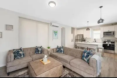 a living room with a couch and a kitchen at Central SD Townhome 2 King Beds Zoo DT North Park in San Diego