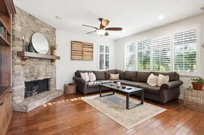 a living room with a couch and a fireplace at Quiet Carlsbad Home One and a Half Miles from the Beach in Carlsbad
