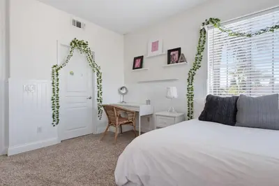 a bedroom with a bed and a desk in it at Quiet Carlsbad Home One and a Half Miles from the Beach in Carlsbad