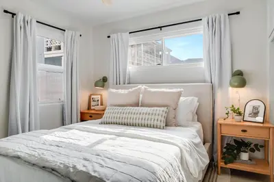 a bedroom with a white bed and two windows at Jewell Street Gem - 3 properties in 1 in San Diego