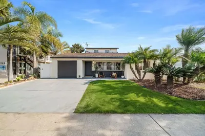 a house with palm trees in front of a driveway at Jewell Street Gem - 3 properties in 1 in San Diego