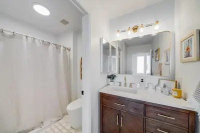 a bathroom with a sink and a toilet and a mirror at Jewell Street Gem - 3 properties in 1 in San Diego