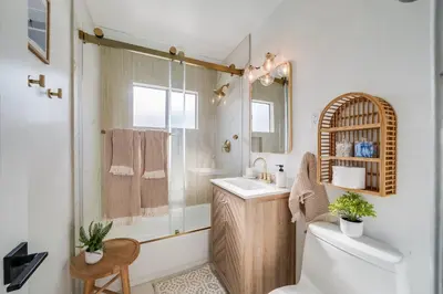 a bathroom with a toilet and a sink and a shower at Jewell Street Gem - 3 properties in 1 in San Diego