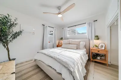 a white bedroom with a bed and a window at Jewell Street Gem - 3 properties in 1 in San Diego