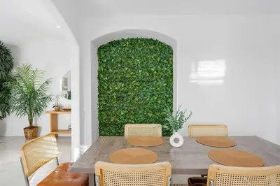 a dining room table with chairs and a green wall at Mountains Views with Pool & Basketball, Relax & Play! in Escondido