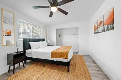 a bedroom with a bed and a ceiling fan at Mountains Views with Pool & Basketball, Relax & Play! in Escondido
