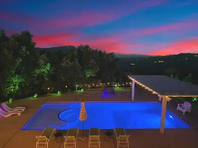 a view of a swimming pool at night at Private Pickleball Villa, Pool Oasis & Chic Casita in Fallbrook