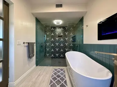 a bathroom with a tub and a glass shower at Private Pickleball Villa, Pool Oasis & Chic Casita in Fallbrook