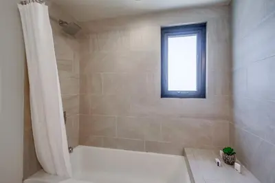 a bathroom with a white tub and a window at Ocean Park Combo 9 & 10 in San Diego