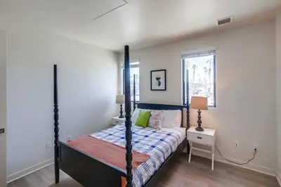 a bedroom with a canopy bed and a window at Ocean Park Combo 9 & 10 in San Diego