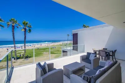 a balcony with chairs and a table and a view of the beach at Ocean Park Combo 9 & 10 in San Diego