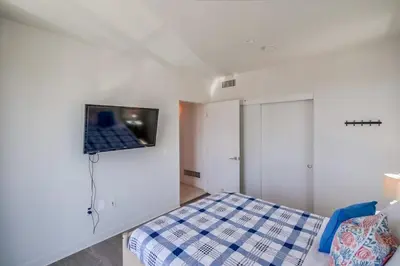 a bedroom with a bed and a tv on the wall at Ocean Park Combo 9 & 10 in San Diego