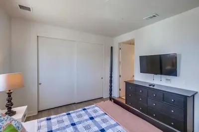 a bedroom with a dresser with a television on it at Ocean Park Combo 9 & 10 in San Diego