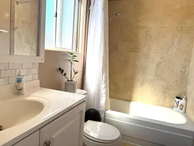a bathroom with a sink and a toilet and a shower at Mina Home in San Diego