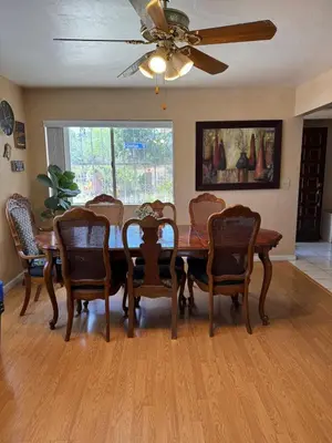 a dining room with a wooden table and chairs at Mina Home in San Diego