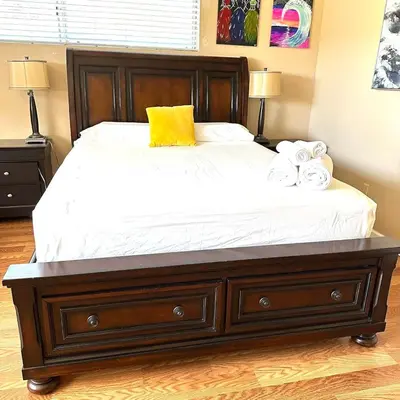 a bedroom with a large bed with towels on it at Mina Home in San Diego