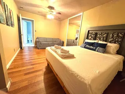 a bedroom with a bed and a living room at Mina Home in San Diego