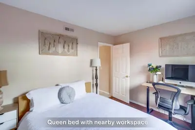 a bedroom with a bed with a desk and a tv at Entire Private Home with 4 Bedrooms - 3 Bathrooms, Big Yard, Garage, King Bed, Crib, Available Now in San Diego