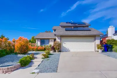 a house with a garage in a yard at Entire Private Home with 4 Bedrooms - 3 Bathrooms, Big Yard, Garage, King Bed, Crib, Available Now in San Diego