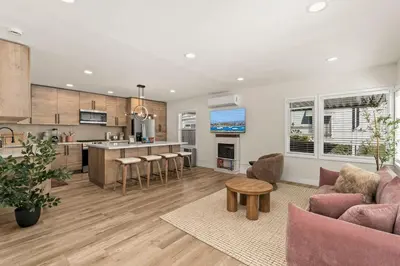 a kitchen and living room with a couch and a table at Palm Haven Retreat Cozy 2BR Near Downtown in San Diego