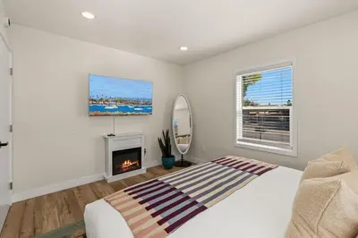 a bedroom with a bed and a fireplace at Palm Haven Retreat Cozy 2BR Near Downtown in San Diego