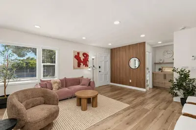 a living room with a pink couch and a table at Palm Haven Retreat Cozy 2BR Near Downtown in San Diego